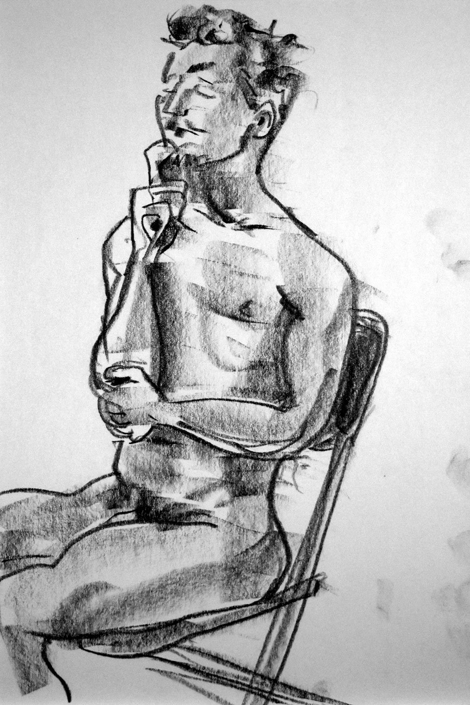 man with thoughtful expression sits in a folding chair with his hand on his chin and eyes closed